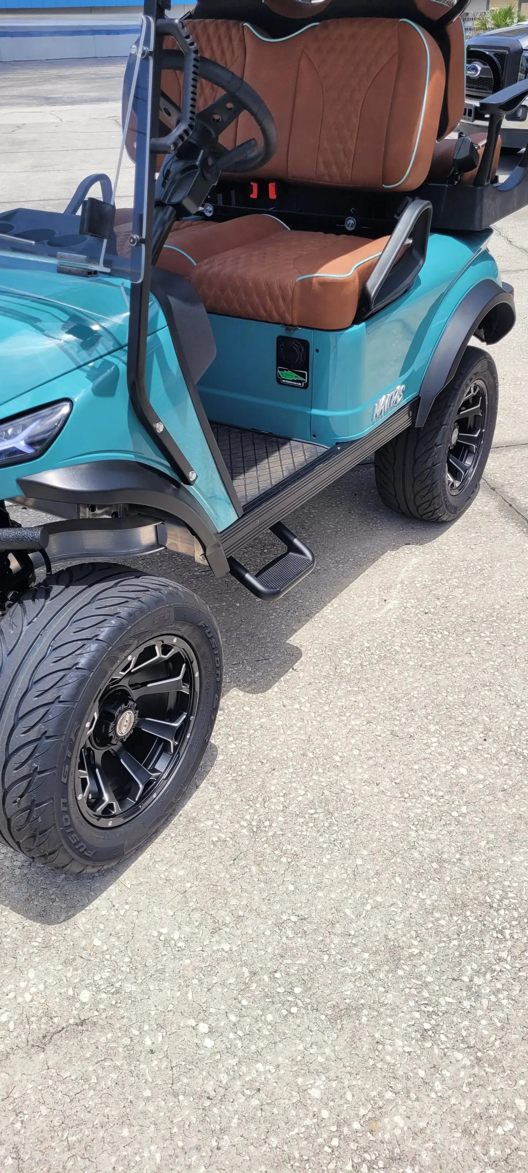 Navitas Lifted Aluminum Chassis Seat Storm with rust seats,  foot step view in EC lot.