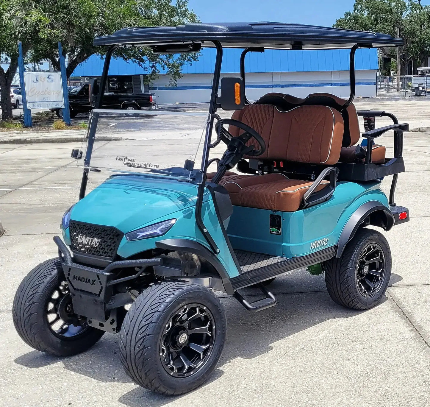 Navitas Lifted Aluminum Chassis Seat Storm with rust seats,  driver front angle view in EC lot.