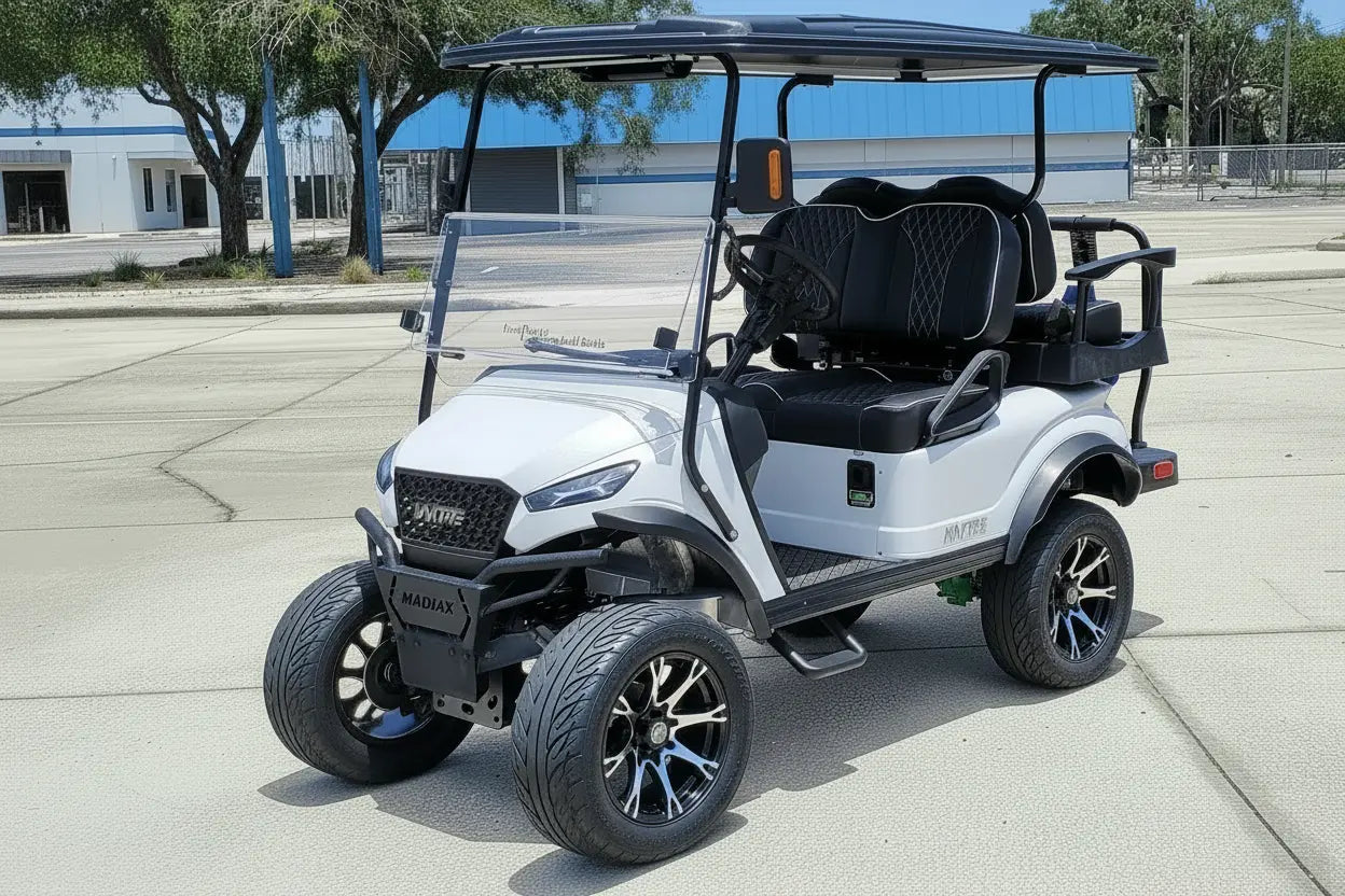 Navitas chassis with a frost white metallic body black seats driver front view in front parking lot