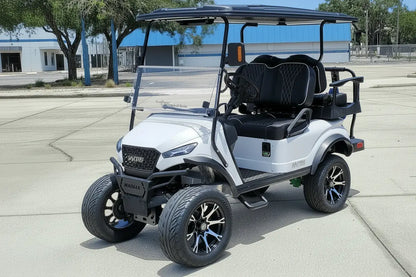 Navitas chassis with a frost white metallic body black seats driver front view in front parking lot