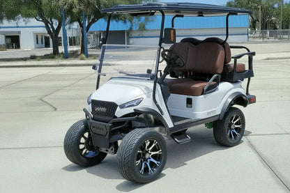 Navitas chassis with a frost white metallic body brown seats driver front view in front parking lot