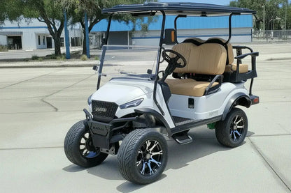 Navitas chassis with a frost white metallic body khaki seats driver front view in front parking lot